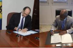 Former CARICOM Secretary General Ambassador Irwin LaRoque and Chairman Warner sign MOU